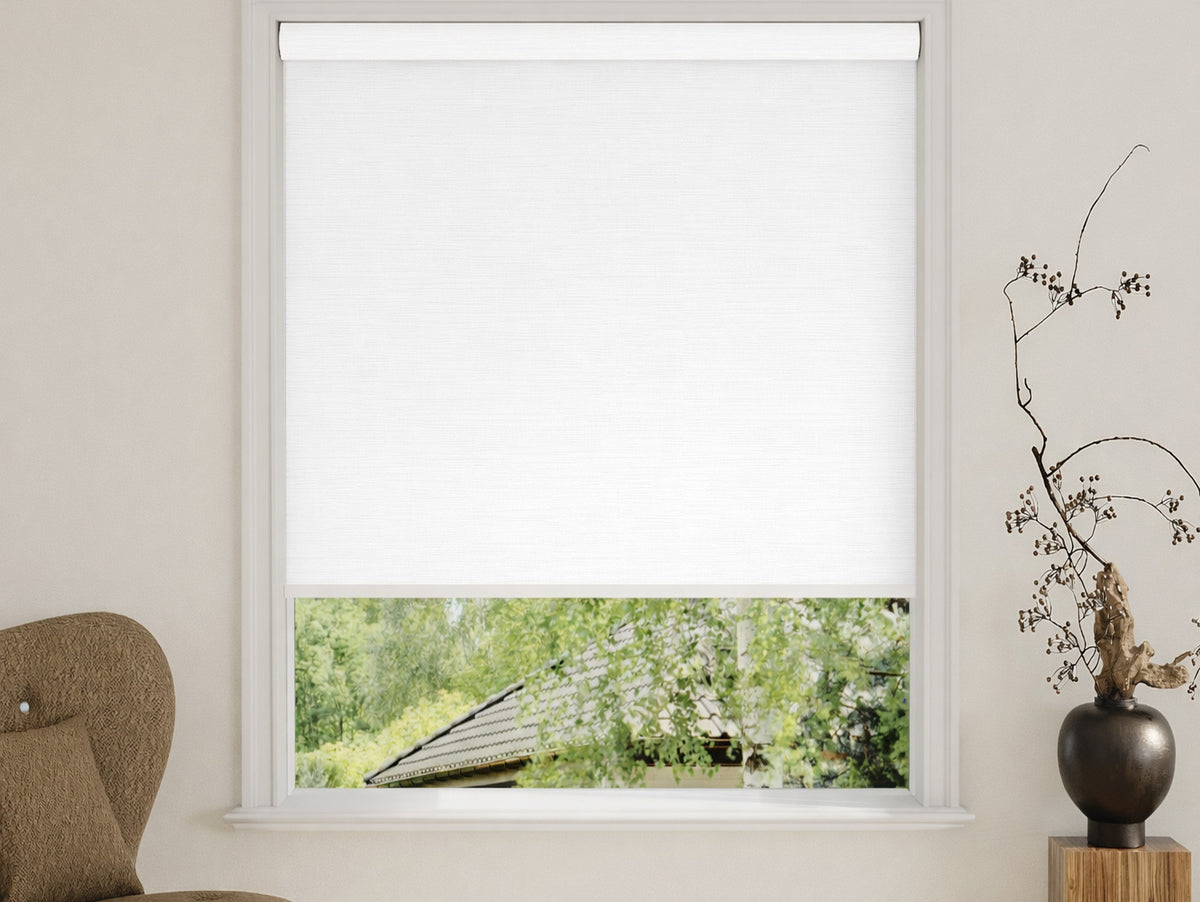 White blackout roller shade covering an interior window