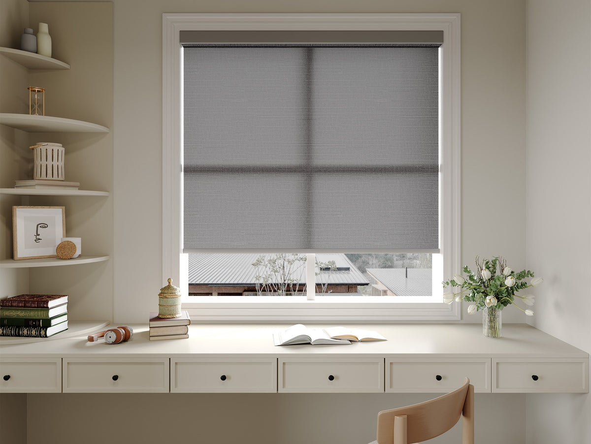Wide roller shade above a home office desk