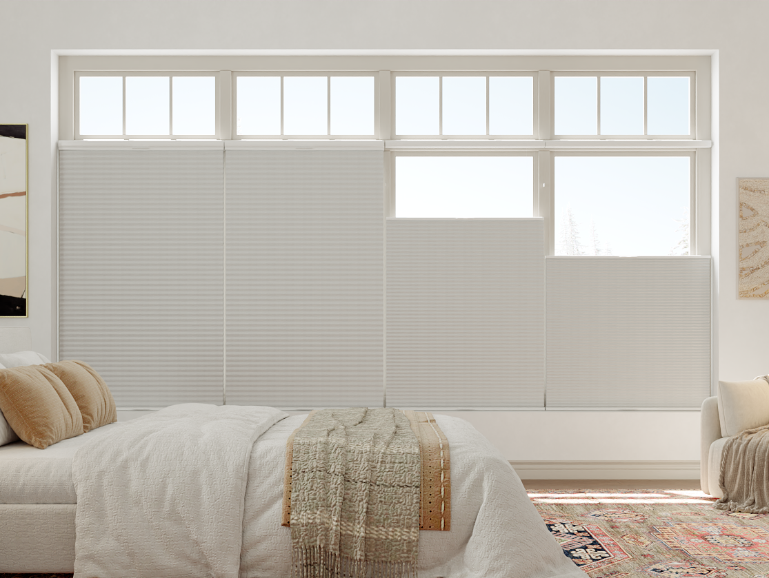 Cellular shades adjusted across bedroom windows