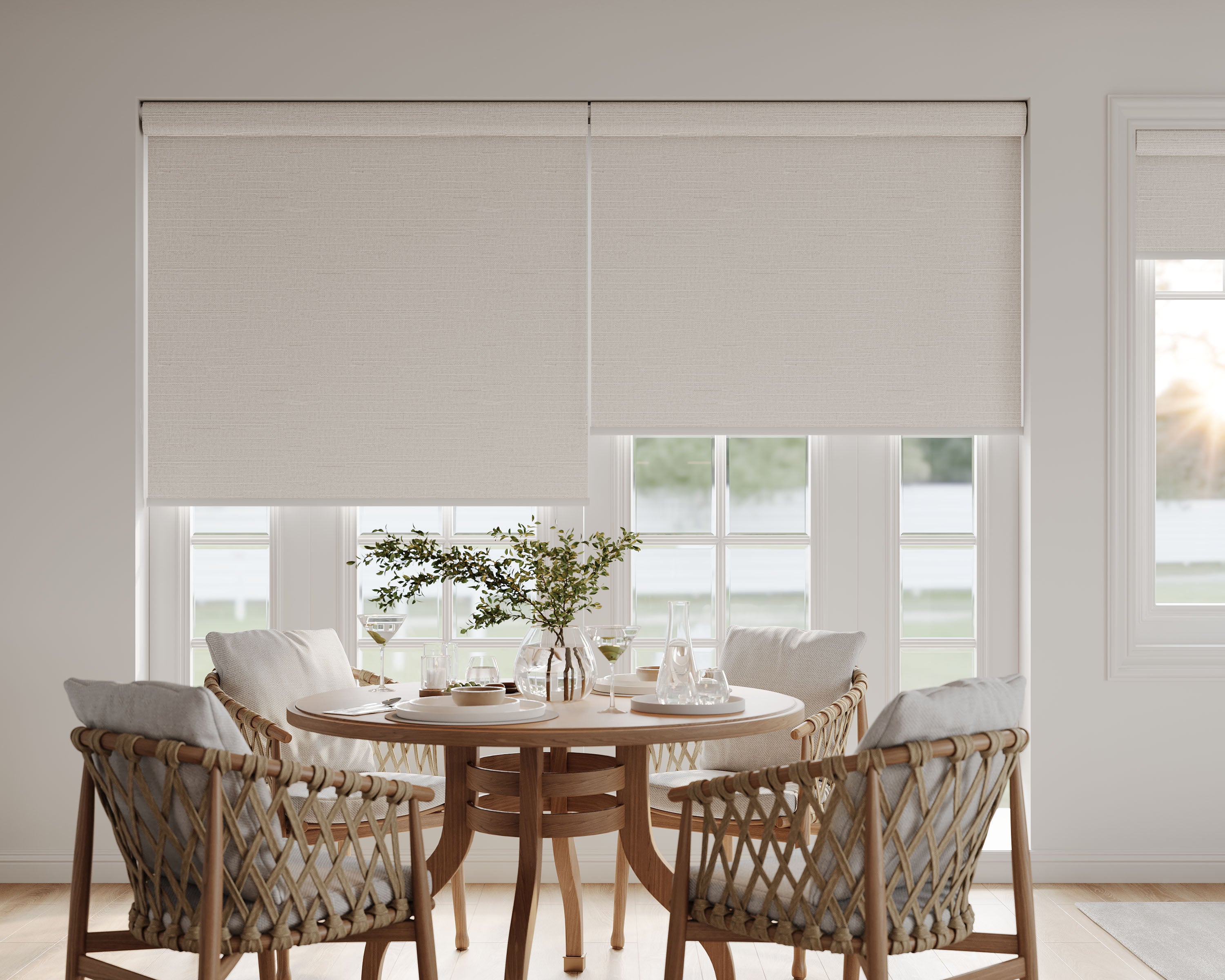 Textured beige roller blinds complementing a wooden table setup.