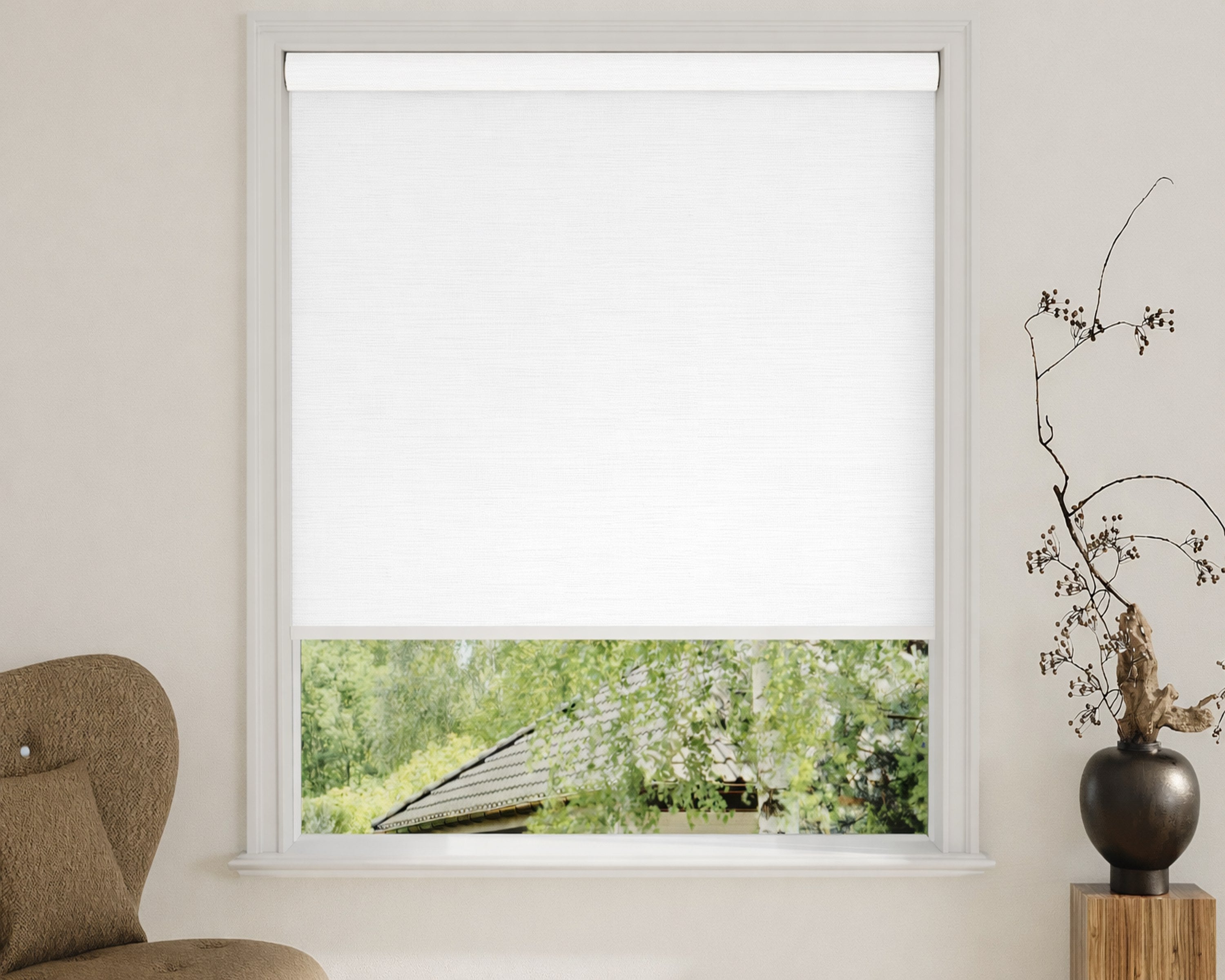 White blackout roller shade beside a wooden side table